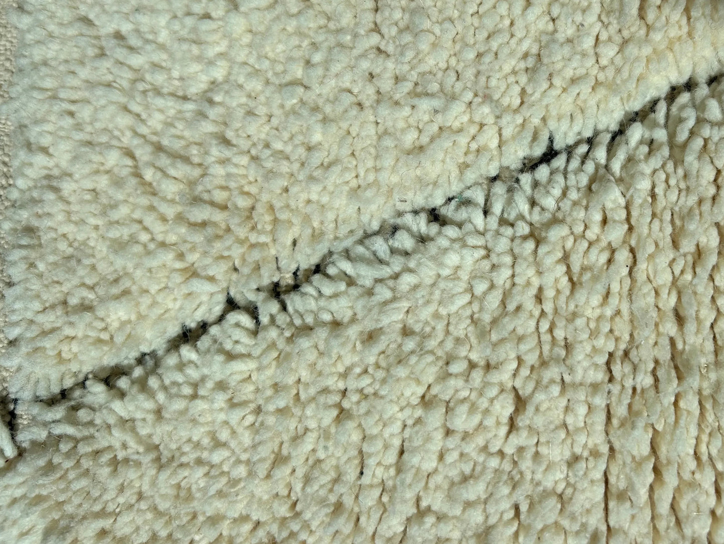 zoom sur tapis de couloir beni ouarain blanc et motif croise noir dans la trame